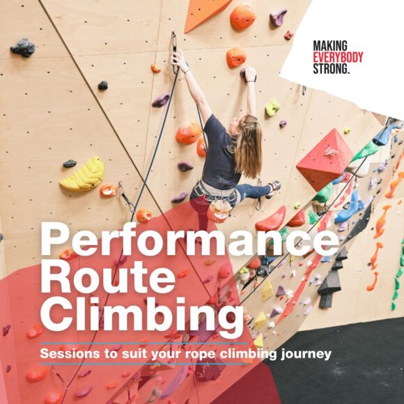 female participant clips a quickdraw on a steep angled wall during a performance route climbing class