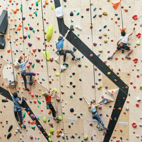 summer camp climbers using auto belay climbing routes