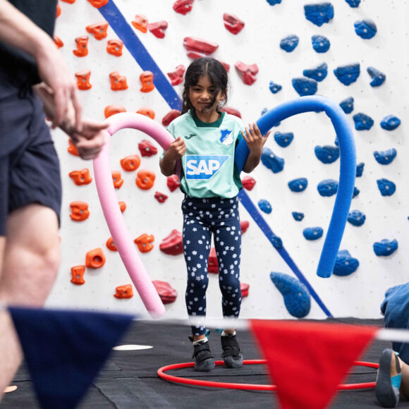 young female participant enjoys a game in the schools climbing classes