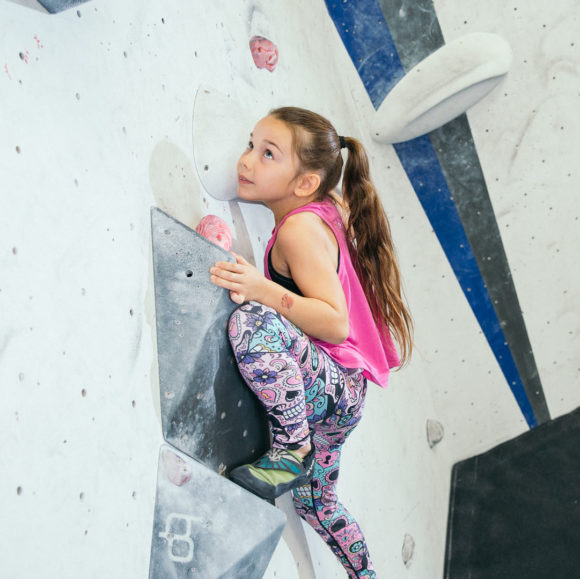 young female climber climbing in manchester