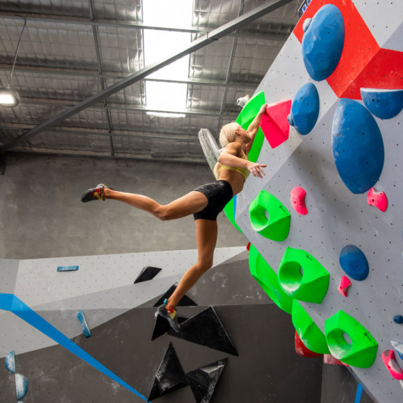 Anna Davey cutting loose with one hand on a hold