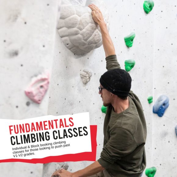 fundamentals cover image of male climbing white hold facing the wakk