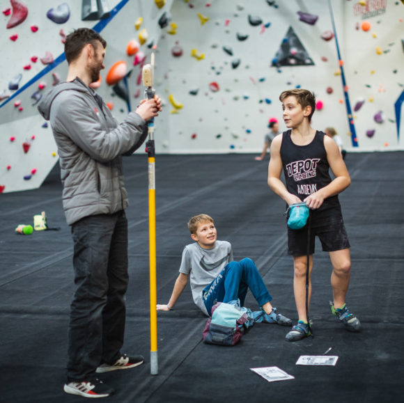 NICAS Coaching students listen to their climbing coach