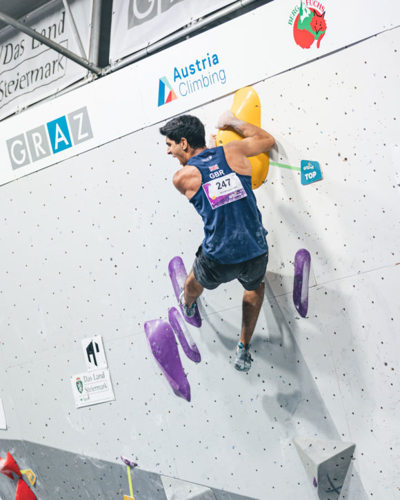 Dayan Akhtar triumphantly celebrates topping the boulder at the IFSC Junior European Championships