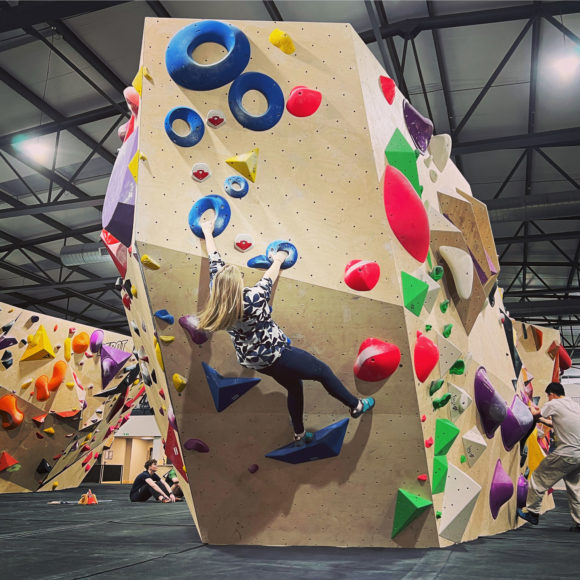 Lucy Keyworth climbs a bouldering wall