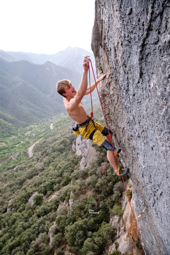 Josh Ibbertson clipping a quickdraw mid route on Esclatamasters, Lleida, Spain